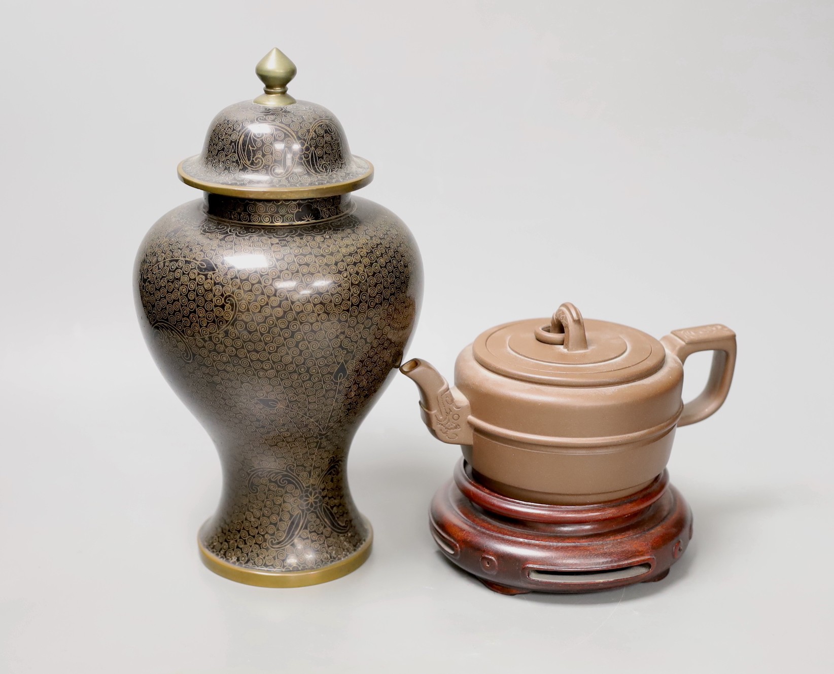 A Chinese cloisonné enamel vase and cover, 25cm tall, and a Chinese Yixing redware teapot